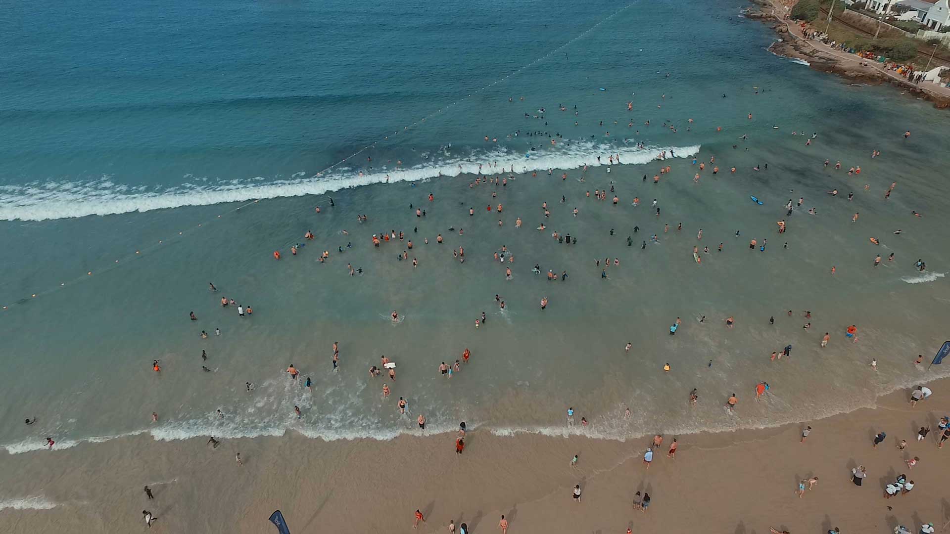 Bathers in Fish Hoek swimming inside the award winning eco-friendly shark exclusion net. The net forms a complete barrier to prevent sharks from entering a portion of the bay and is specifically designed to have minimal environmental impact. © Shark Spotters