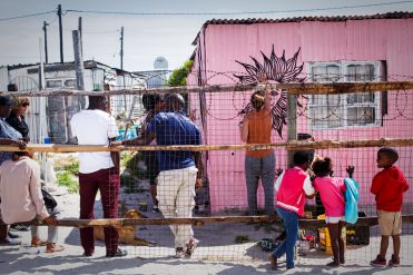 A traveller paints a mural on a township art tou