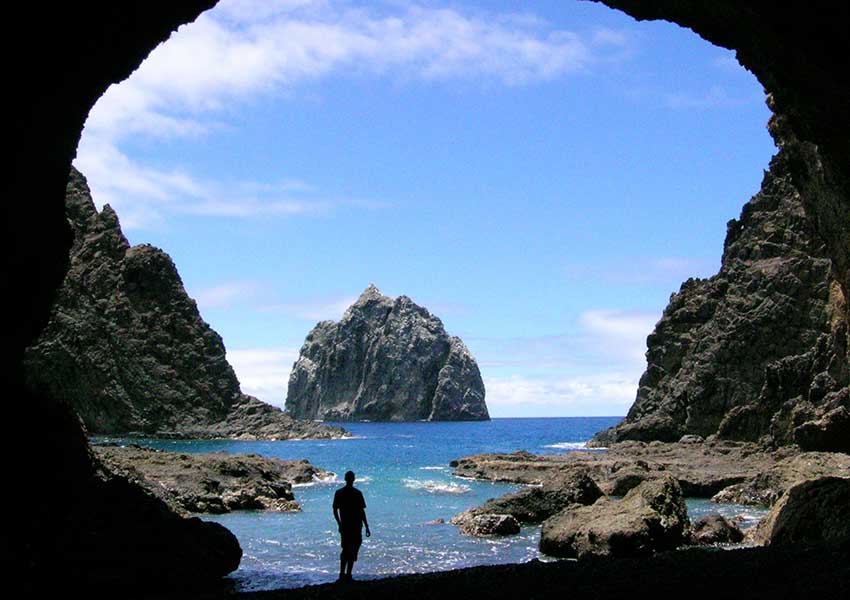 Black rock cave looking out to the sea surrounding St Helena