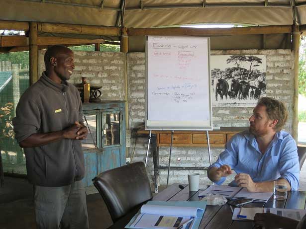 Seliot, a waiter at Wilderness Safaris' Little Makalolo, practises his wine recommendations with Allister – via Wildnerness Safaris